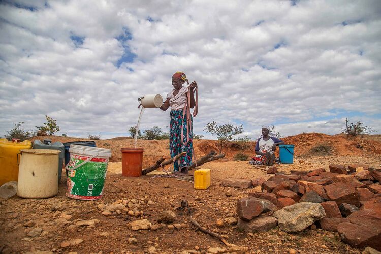 Villagers fetch water from a makeshift borehole in Mudzi, Zimbabwe, on July 2, 2024