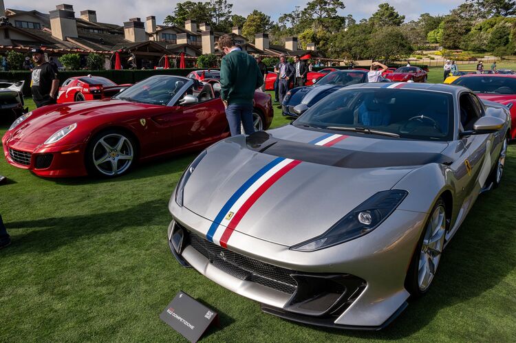 Ferrari cars on a golf course. 