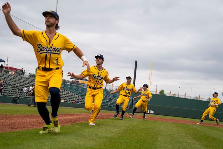 Bananas players jokingly run around the infield