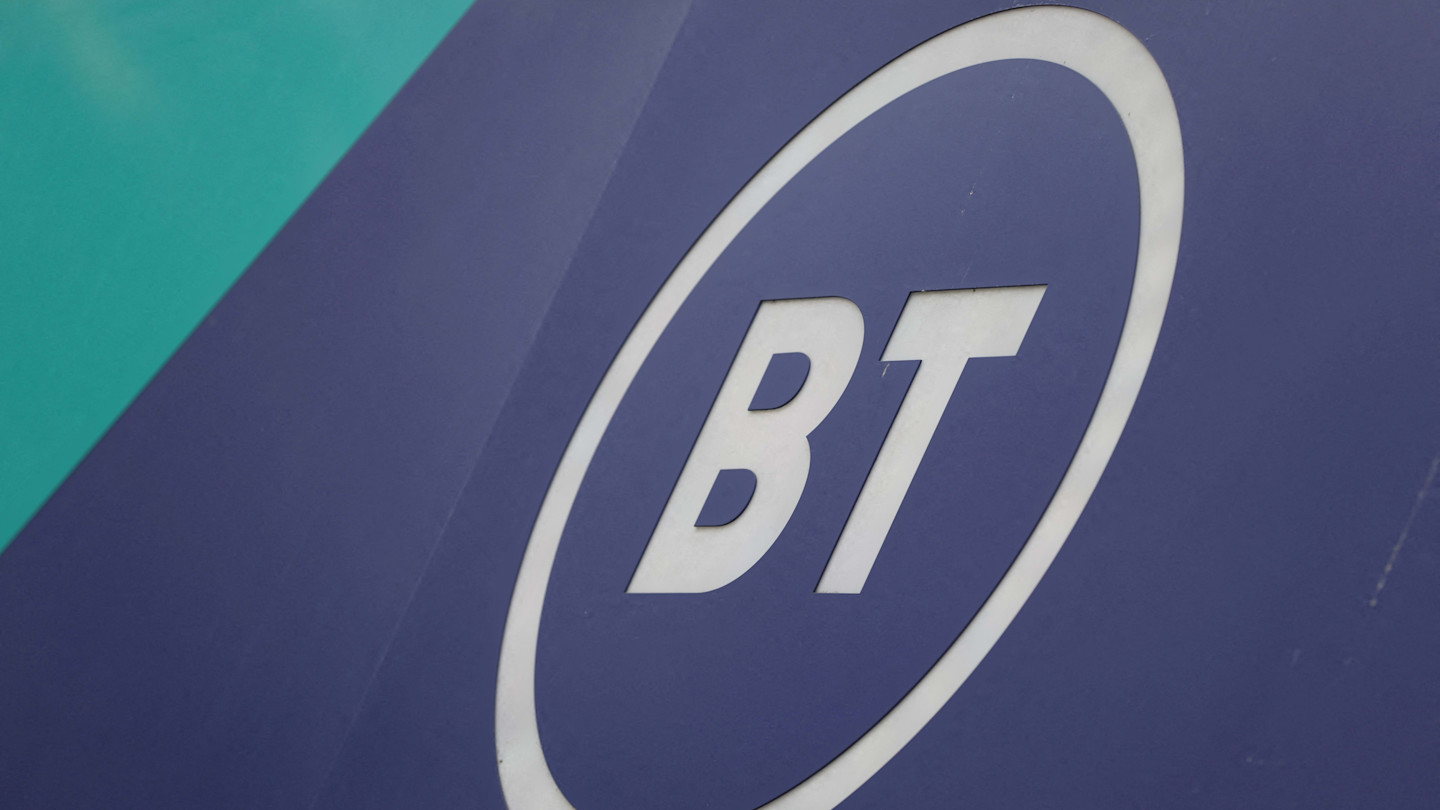 BT Group logo in white letters inside a white oval on a blue shopfront panel.