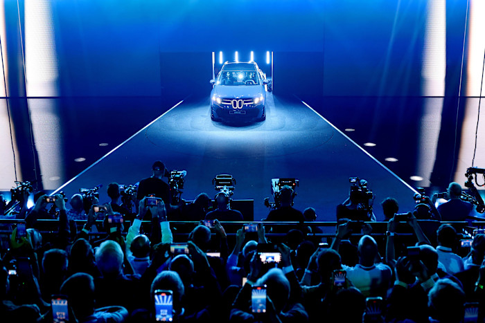 The BMW iX3 electric car is unveiled on a stage 