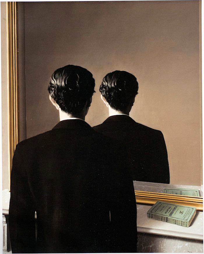 A man in a suit stands before a mirror, but the reflection shows only the back of his head and body, not his face. Two green books rest on the mantel.
