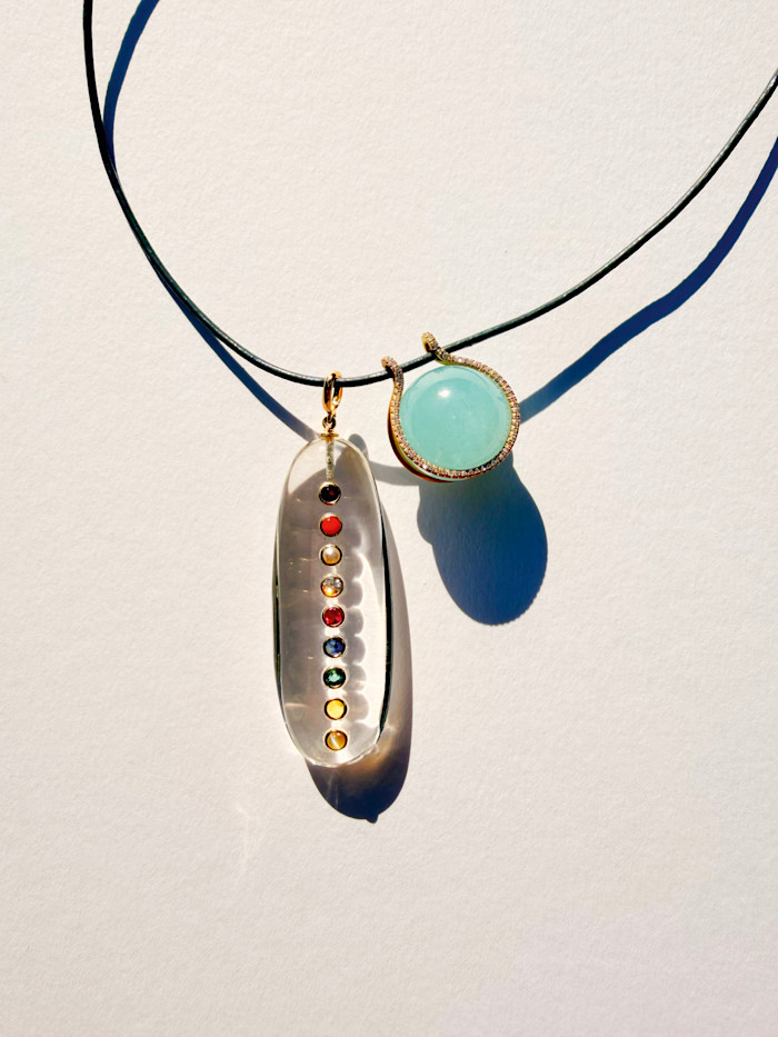 From left: Marisa Klass diamond, quartz, pearl and gemstone Chakra pendant, $6,500, and diamond and aquamarine Mini Healing Sphere on a leather cord, $4,200