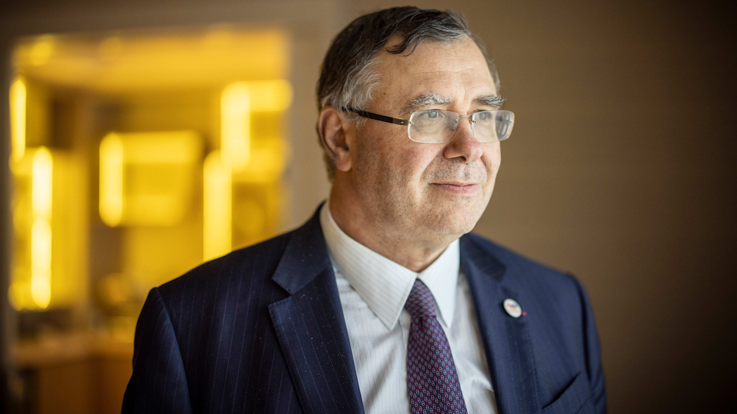 Patrick Pouyanné, chairman and CEO of TotalEnergies, wearing a suit and tie, looking to the side.