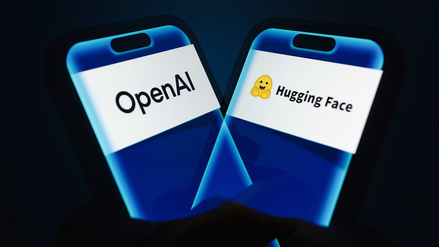 A hand holds a smartphone displaying the logos of OpenAI and Hugging Face side by side on the screen.