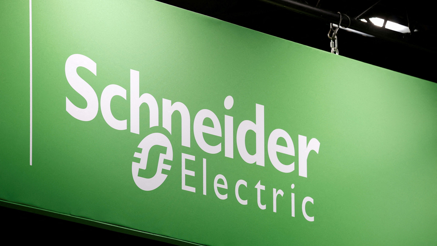 Schneider Electric logo displayed on a green sign at the Global Industrie exhibition.