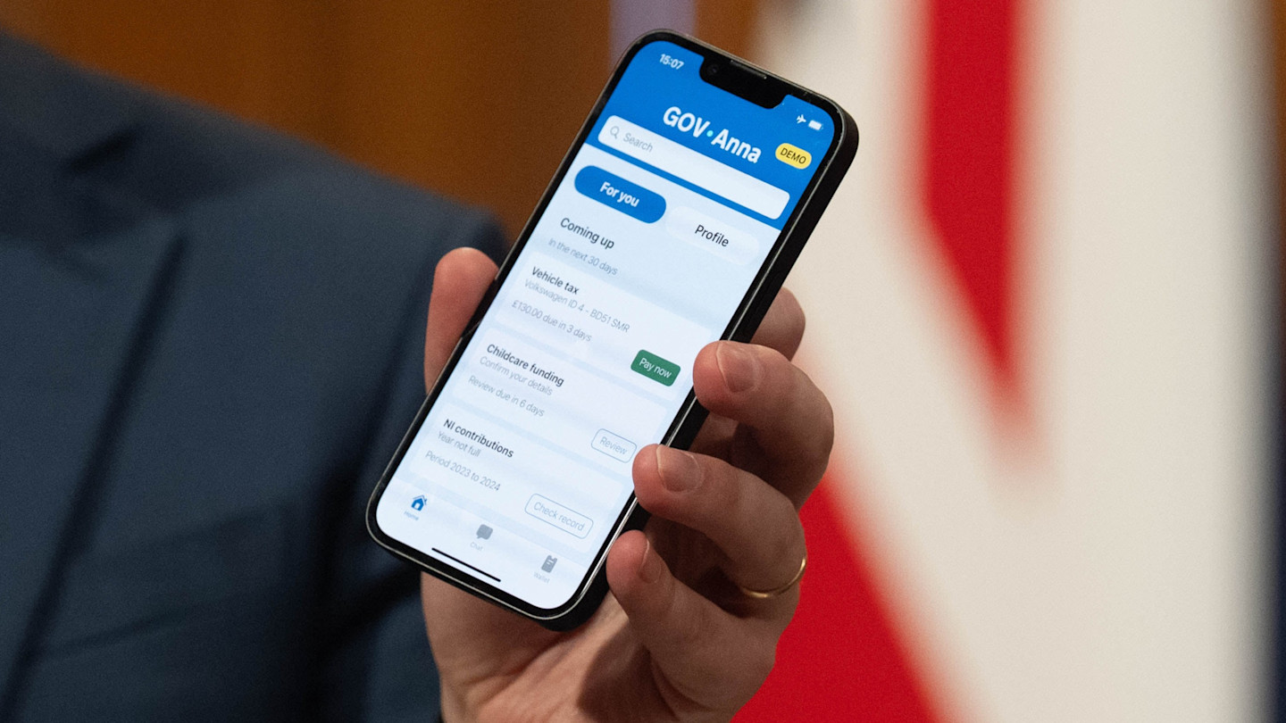 Darren Jones holds a smartphone displaying a prototype government app with digital ID features, showing upcoming tasks and payment options.