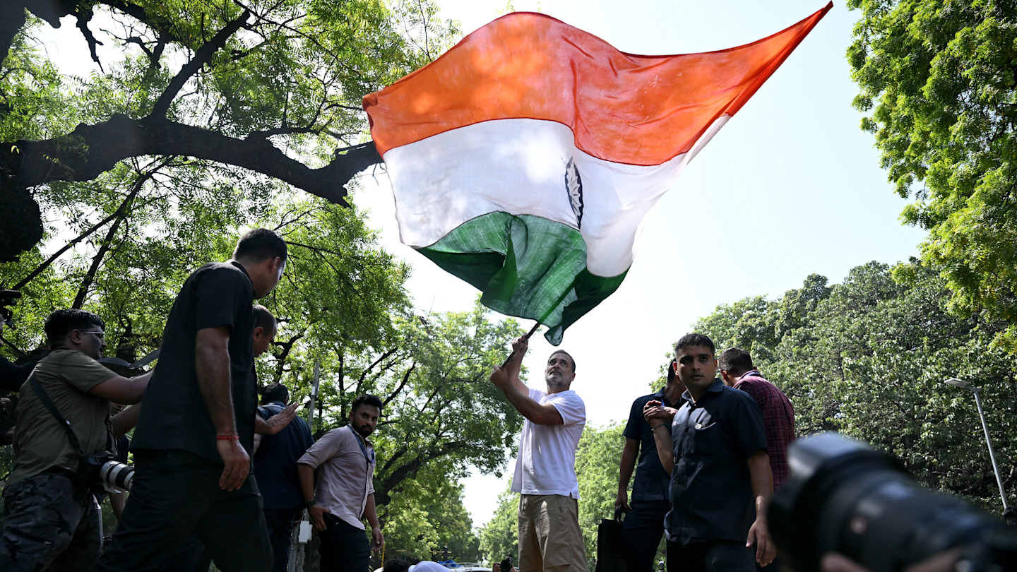 Indian National Congress leader Rahul Gandhi waves India’s national flag during a protest march on Tuesday in New Delhi