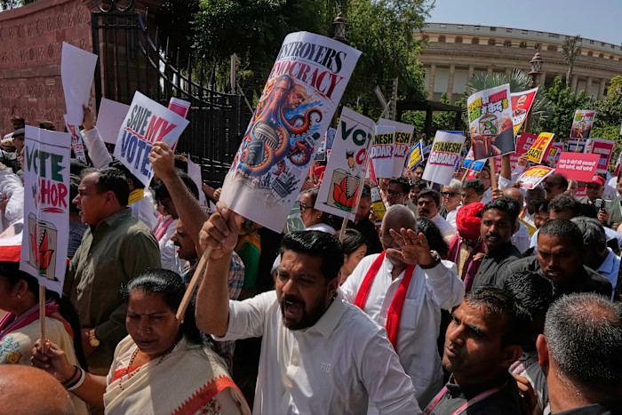 Protesters hold placards as they march in New Delhi