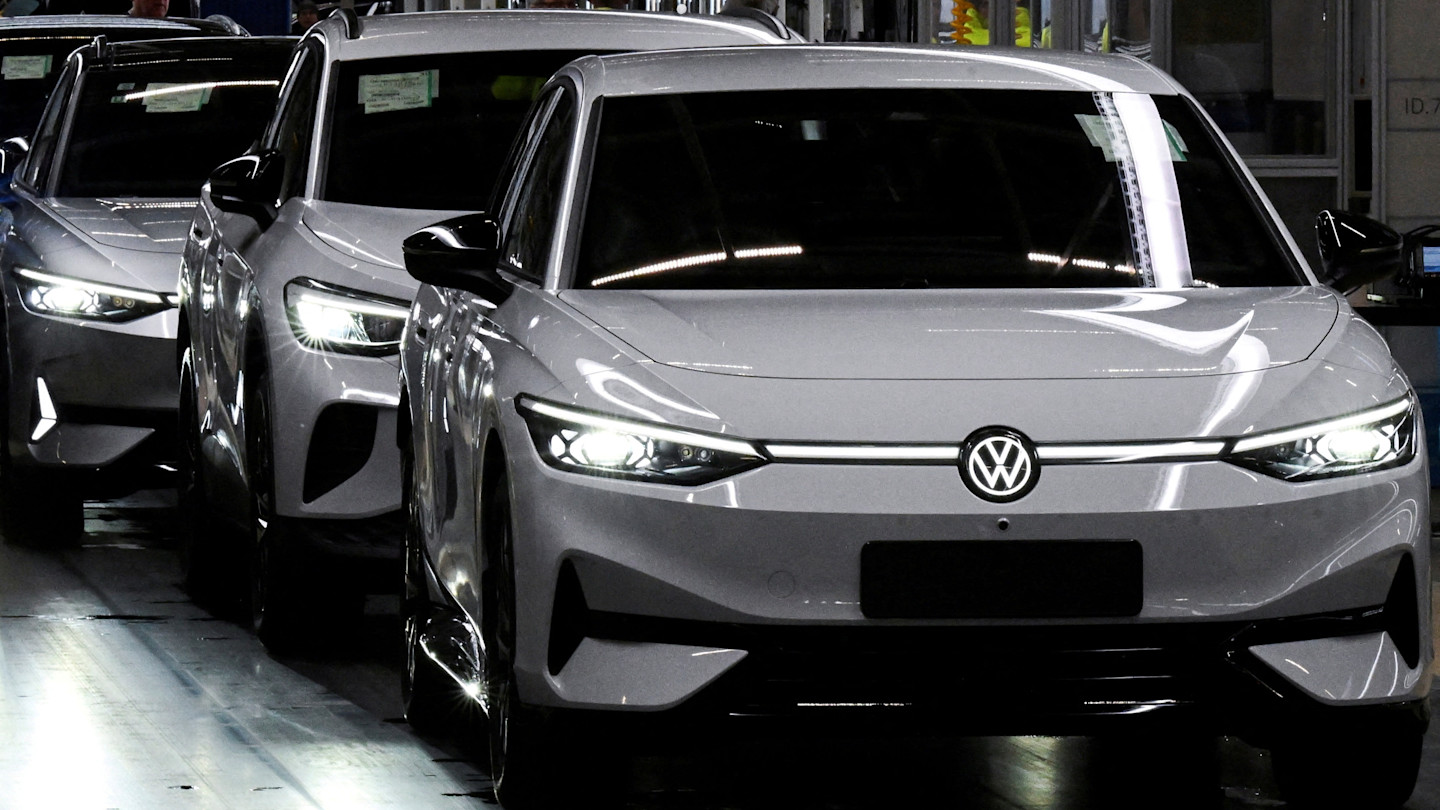 Several Volkswagen ID.7 electric cars in a row on the assembly line at a factory