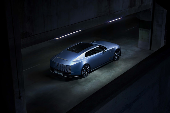 Jaguar Type 01 EV in blue, shown from above and behind in a dimly lit parking garage.