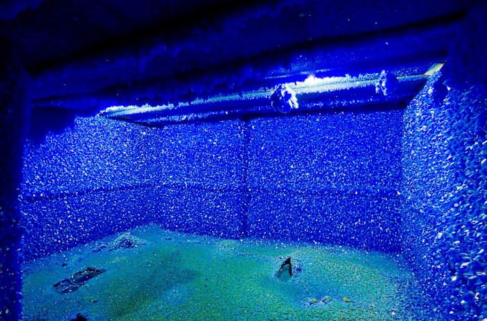 A room covered entirely in vivid blue crystals, with sparkling surfaces on the walls, ceiling and floor.