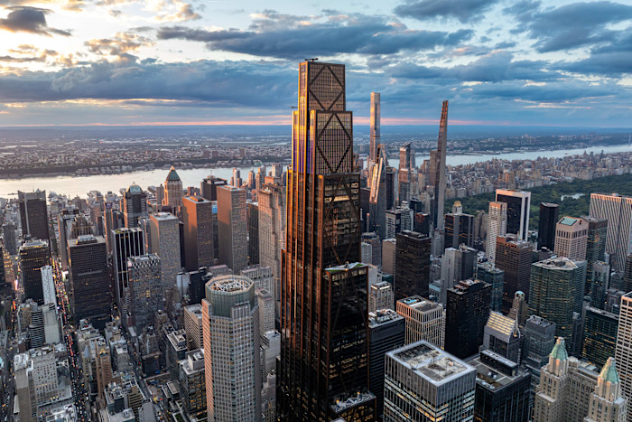 JPMorgan Chase’s world headquarters stands prominently among skyscrapers in the New York City skyline at sunset.
