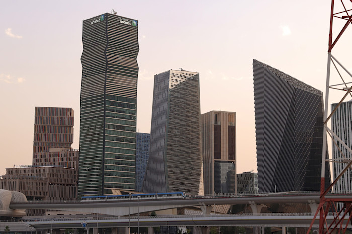 The Aramco headquarters building, left, with its distinctive wavy facade among several modern skyscrapers in Riyadh's King Abdullah Financial District.