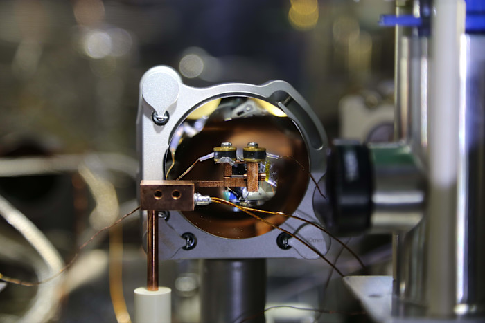 Core assembly of a nuclear optical clock, showing a metallic chamber with copper wiring and precision components.