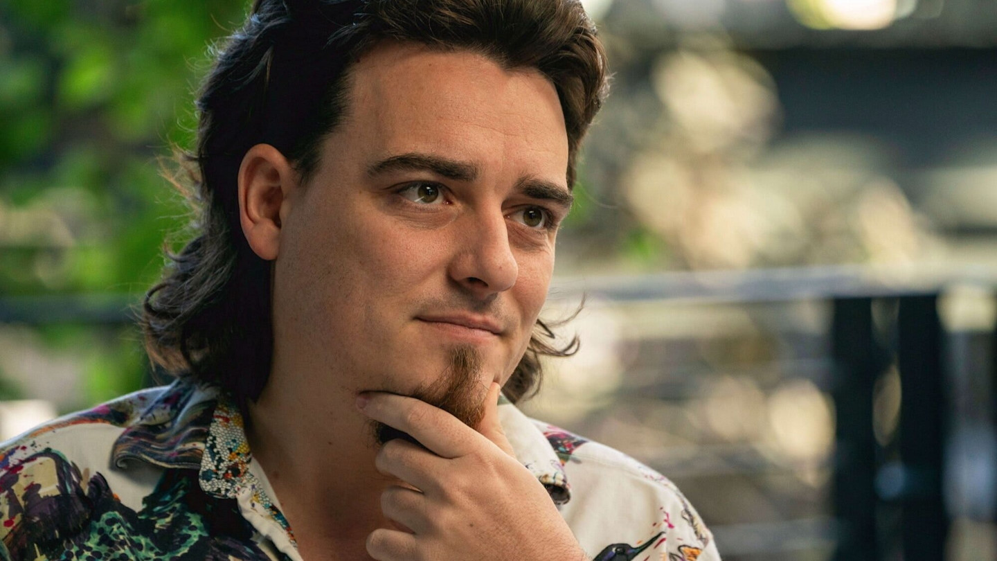Palmer Luckey rests his chin on his hand and looks thoughtful during an interview at Anduril’s headquarters.