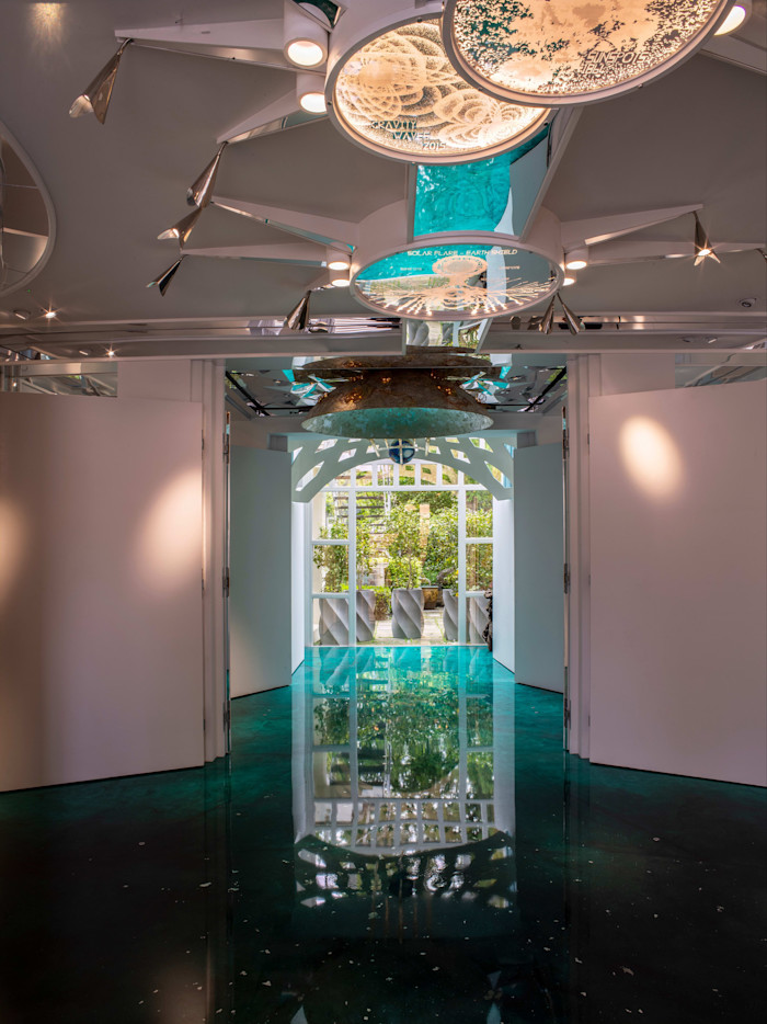 Ceiling lights feature scientific sun diagrams, with a malachite floor and sun-and-earth sculpture by Charles and Lily Jencks above.