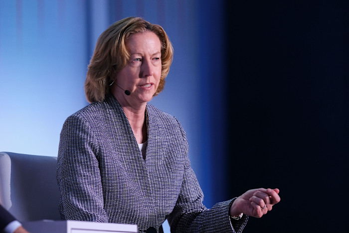 Meg O’Neill speaks on stage wearing a microphone headset at the 2024 CeraWeek conference.