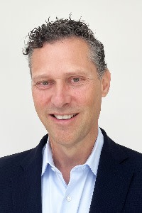 Gordon McCue, head of legal operations at Shell, smiling and wearing a dark jacket over a light blue collared shirt.