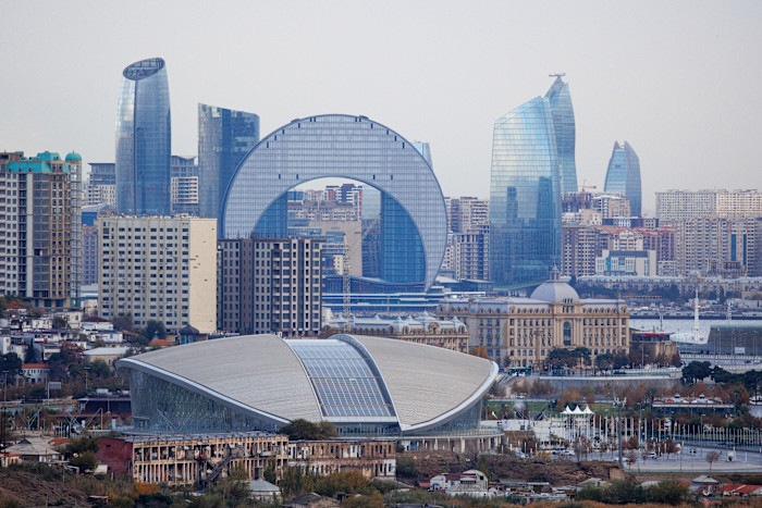 Modern high-rise buildings and distinctive architecture along the Caspian Sea waterfront in Baku, Azerbaijan.