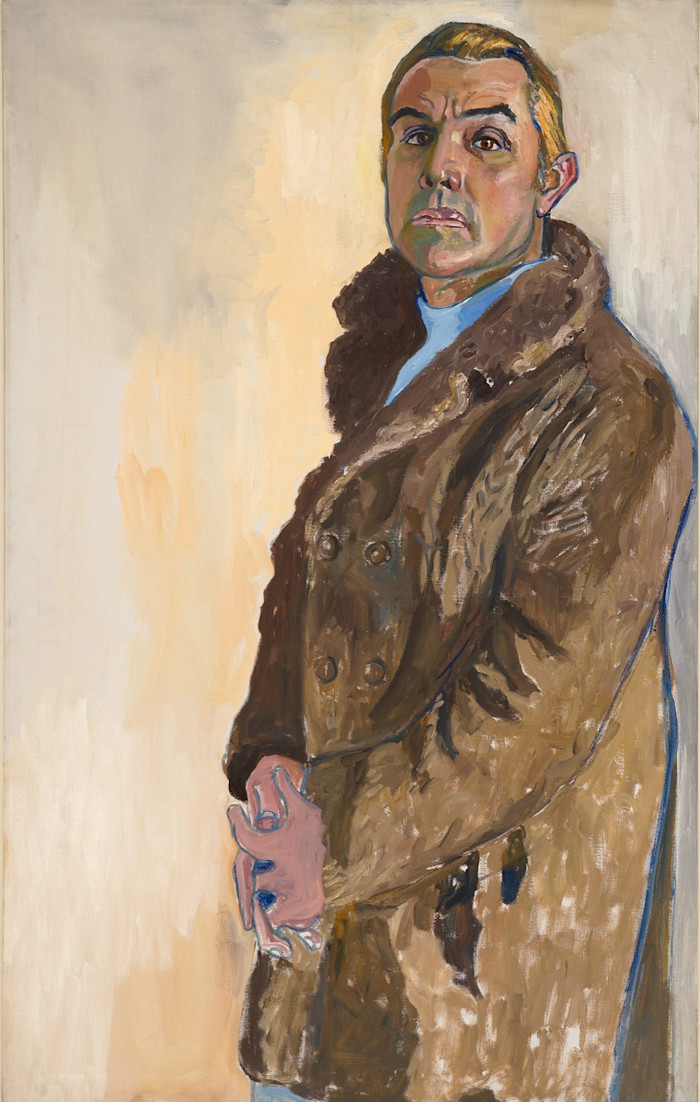 Kris Kirsten stands facing forward in a brown fur-collared coat, hands clasped, against a neutral background.