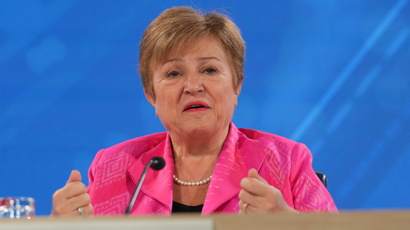 Kristalina Georgieva speaks at a press briefing, gesturing with both hands while seated at a table.