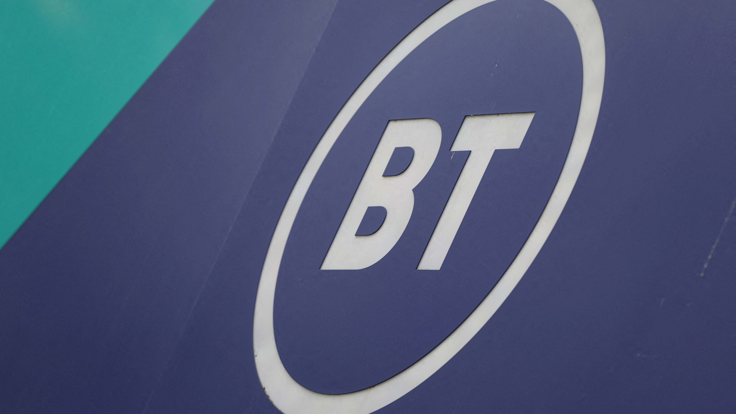 BT Group logo in white letters inside an oval on a blue shopfront.