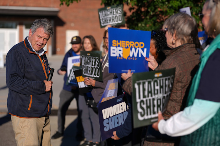 Sherrod Brown speaks to supporters holding campaign signs, including “Sherrod Brown for Ohio” and “Teachers for Sherrod.”