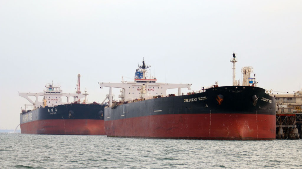 Oil tankers, including one named Crescent Moon, docked at a floating platform offshore near Al Faw, Iraq.