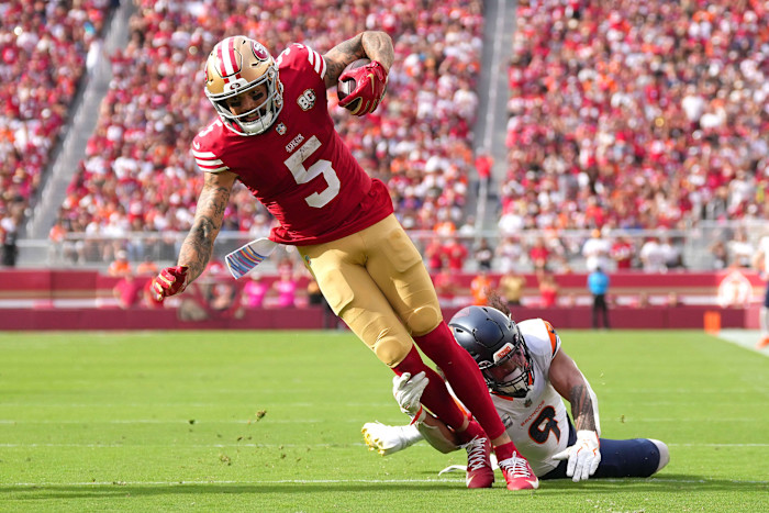Mike Evans of the San Francisco 49ers is tackled near the goal line by Talanoa Hufanga of the Denver Broncos during a game.
