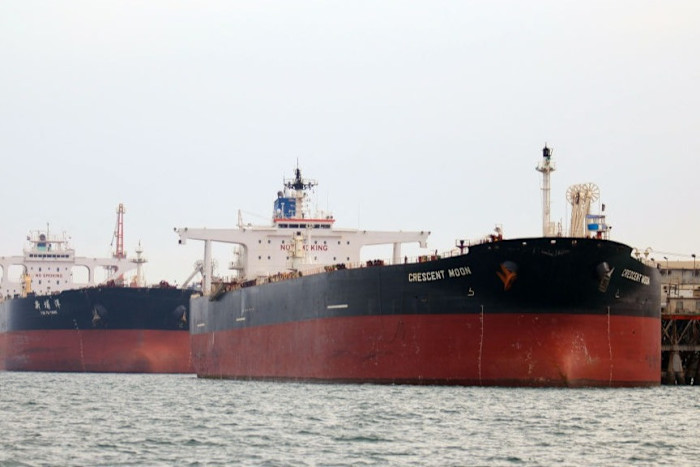 Oil tankers, including one named Crescent Moon, docked at a floating platform offshore near Al Faw, Iraq.