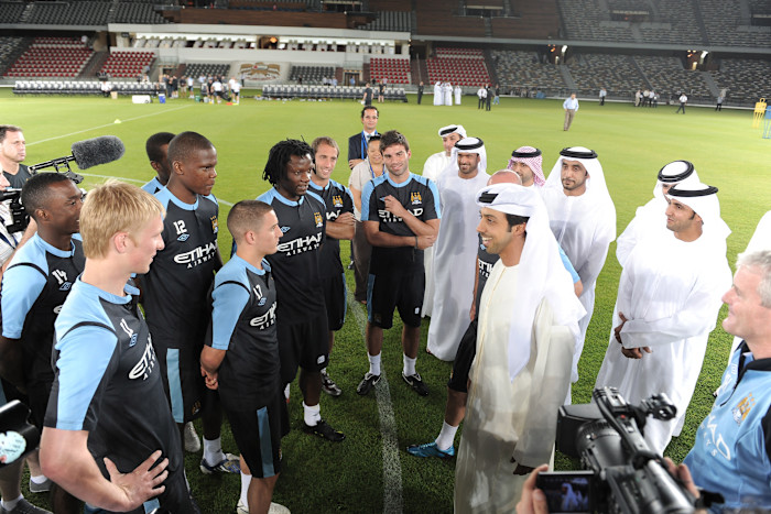 Sheikh Mansour Bin Mohammed Bin Rashid Al Maktoum meets Manchester City players and staff on the pitch during a training session.