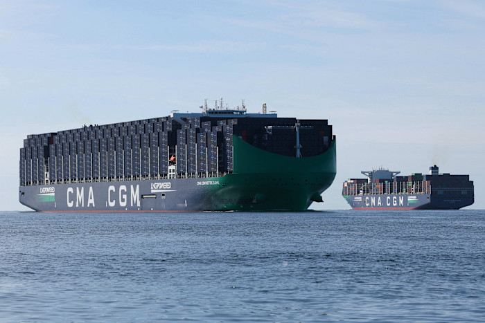 The CMA CGM Notre Dame container ship sails past another CMA CGM ship on the water near Le Havre.