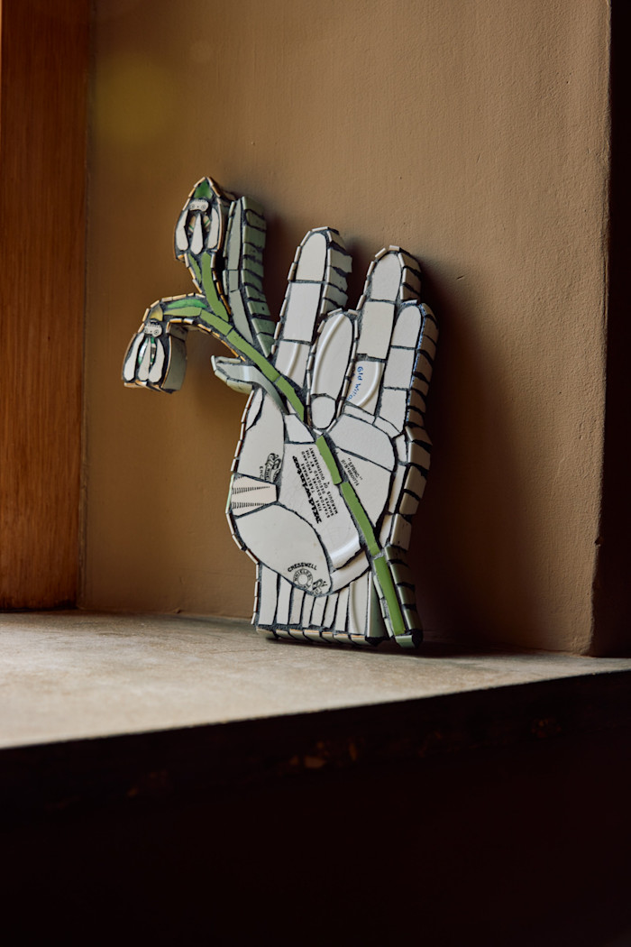 Mosaic of a hand holding a snowdrop by Pearson’s friend, Cleo Mussi