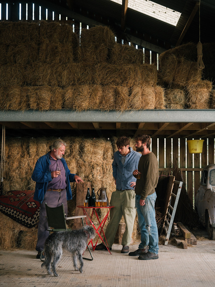 Seal with his sons, Ned and Alfred, tasting cider in a barn on the farm