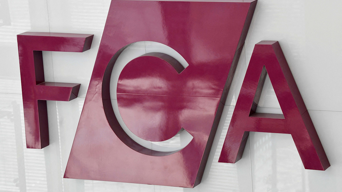 Large maroon FCA letters mounted on a white wall, representing the Financial Conduct Authority's logo.