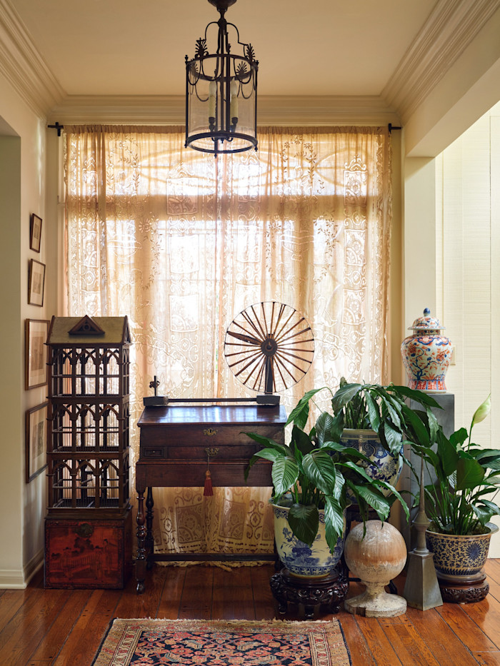 A 19th-century birdcage, Japanese bamboo spinning wheel and 1880 Chinese yew chest in the hall
