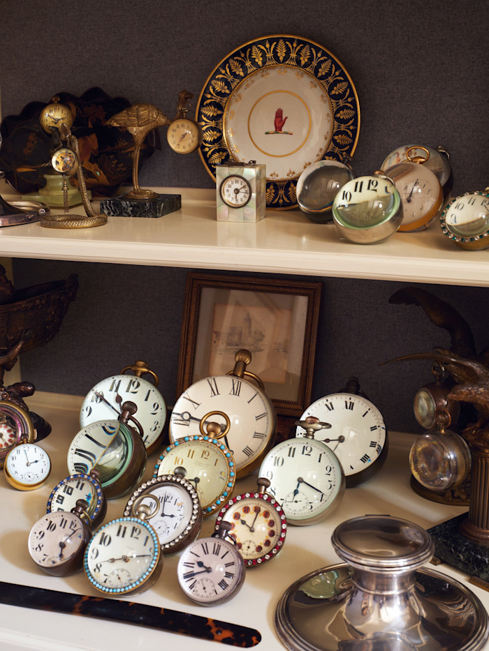 A collection of antique ball clocks in the study ranging from Tiffany & Co and Mark Cross to assorted jewelled clocks