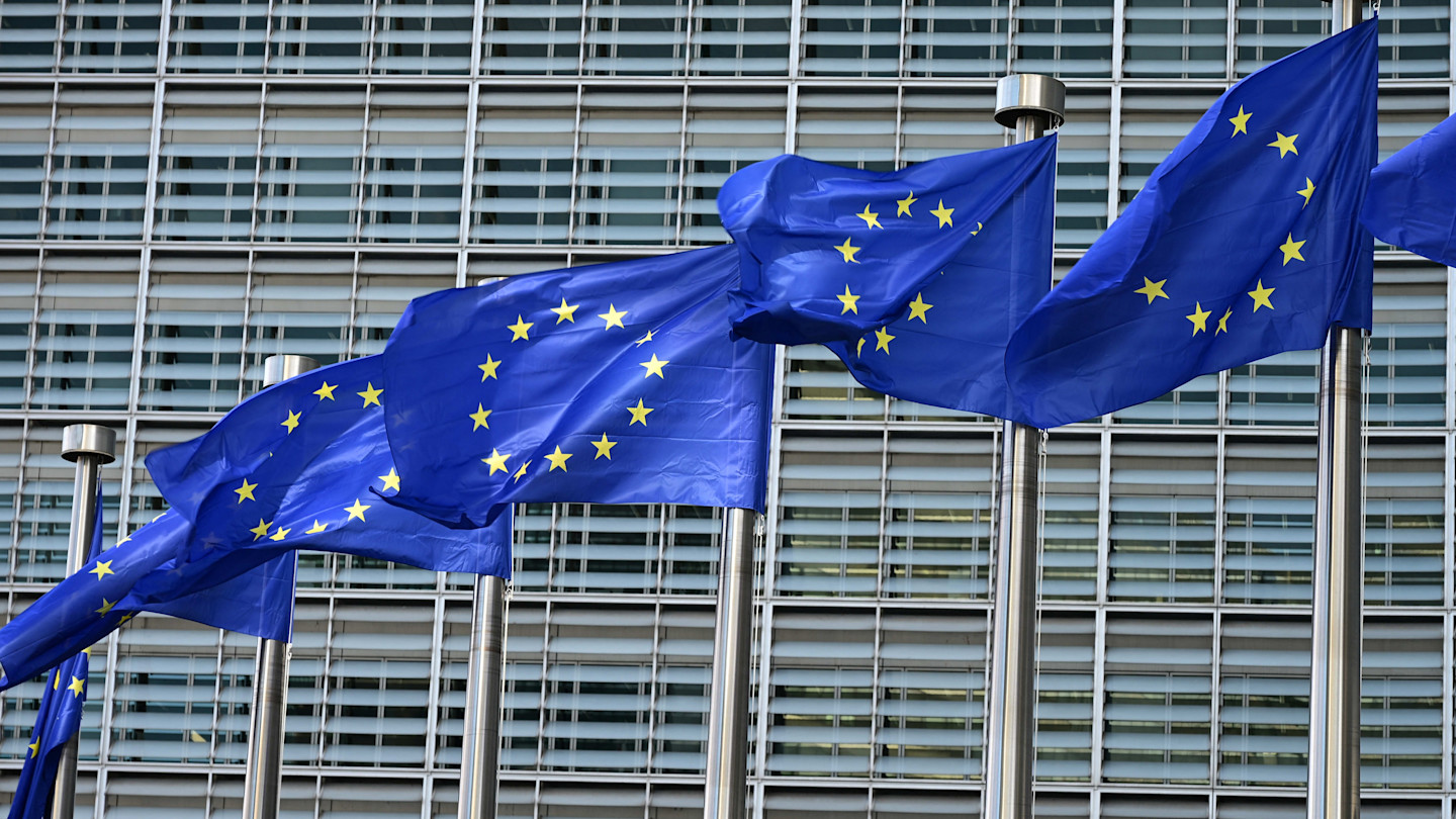 EU flags flutter on flagpoles in front of the Berlaymont building, the EU Commission headquarters