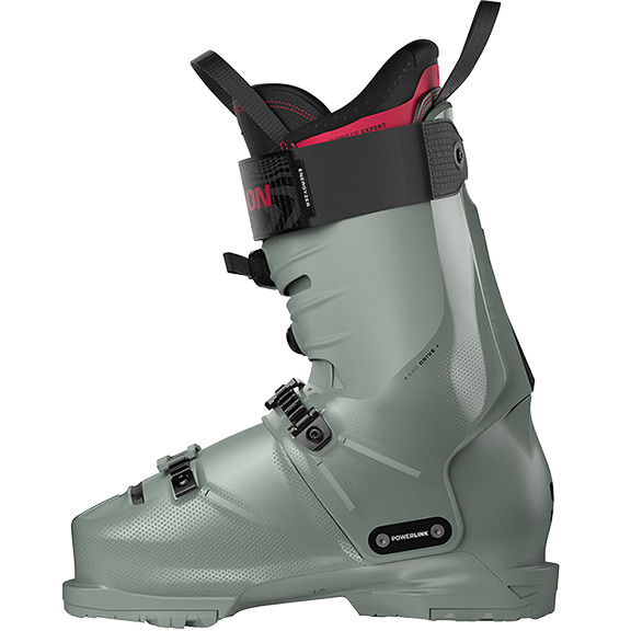 A grey ski boot with black buckles and red detailing.