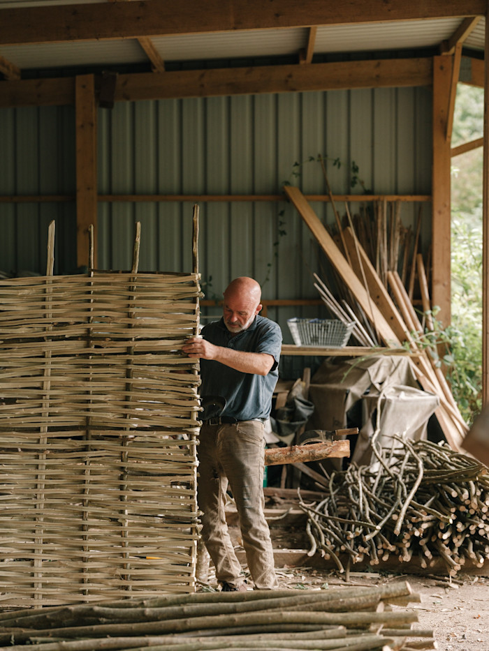 Parsons weaving willows strips in his workshop