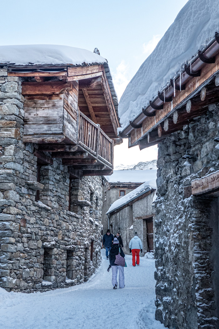A narrow street with stone chalets