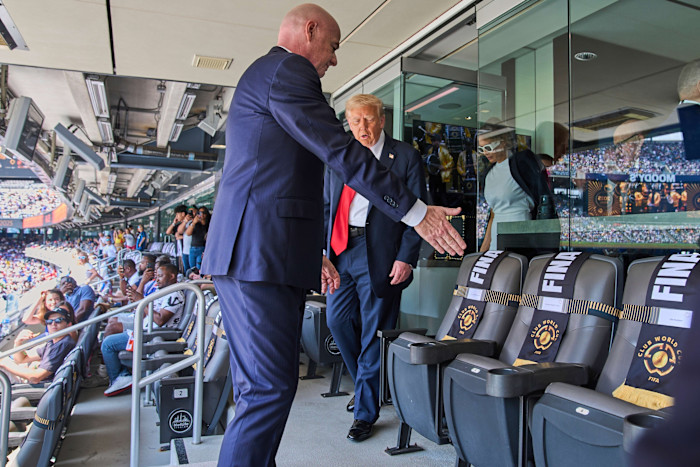 Fifa President Gianni Infantino gestures towards seats as President Donald Trump and first lady Melania Trump prepare to sit at the Club World Cup final.