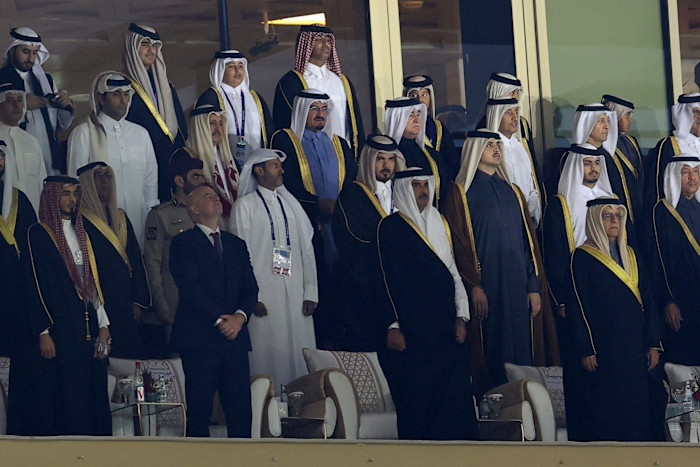 Fifa president Gianni Infantino and Qatar's Emir, Sheikh Tamim bin Hamad al-Thani, stand among a group of officials before a match.