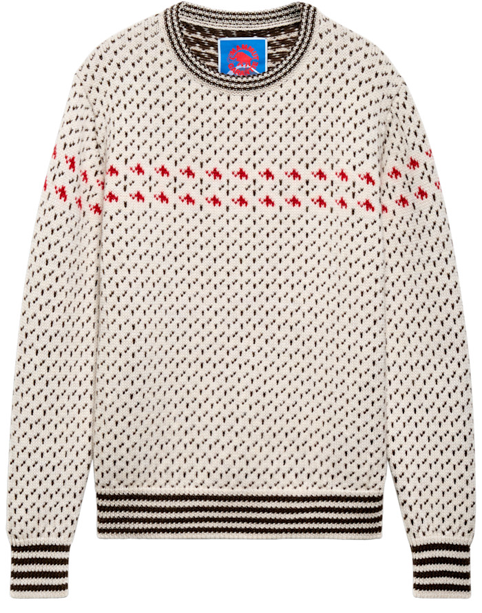 A cream knitted jumper with red motifs and striped brown cuffs and hem.