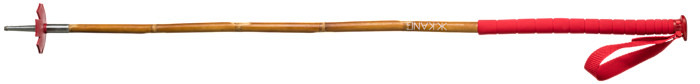 A bamboo ski pole with a red handle, wrist strap and basket.