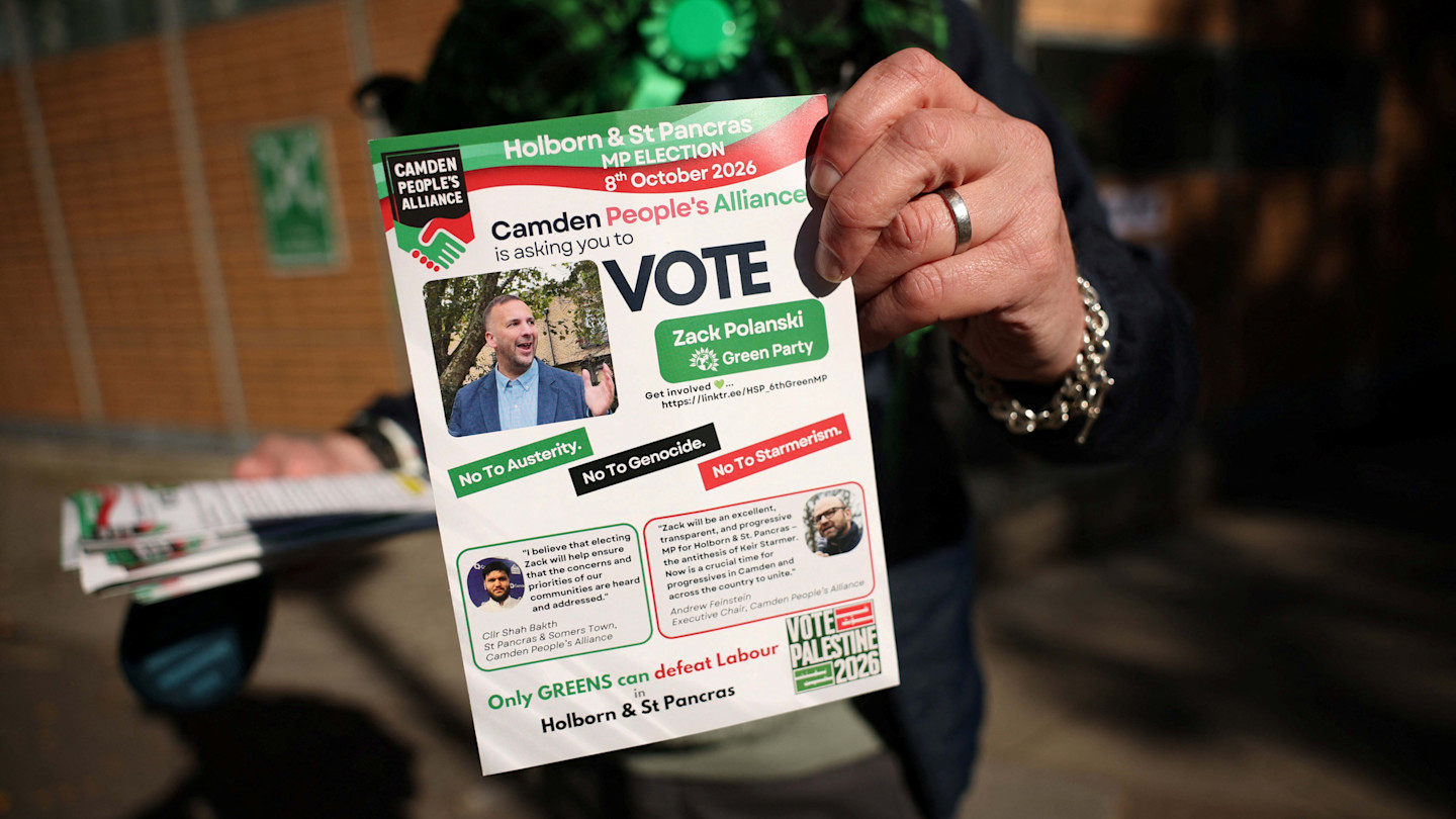 A Green Party supporter holds a flyer urging voters to support Zack Polanski in the Holborn and St Pancras by-election.