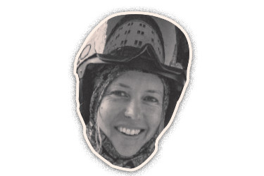 Black-and-white cut-out portrait of a smiling woman wearing a ski helmet