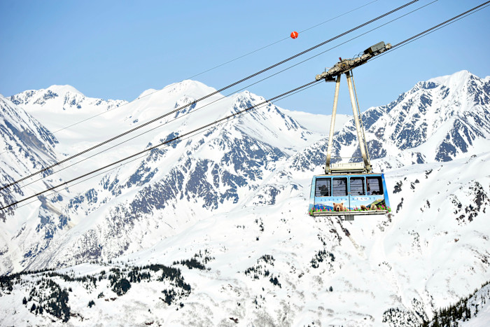 A cable car with mountains behind
