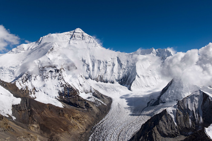 The north face of Mount Everest covered in snow and ice, with a large glacier flowing down the mountain.